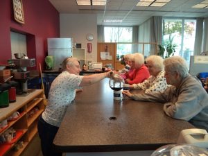 Panorama Help Homeless Seniors Serving Coffee at Senior Center