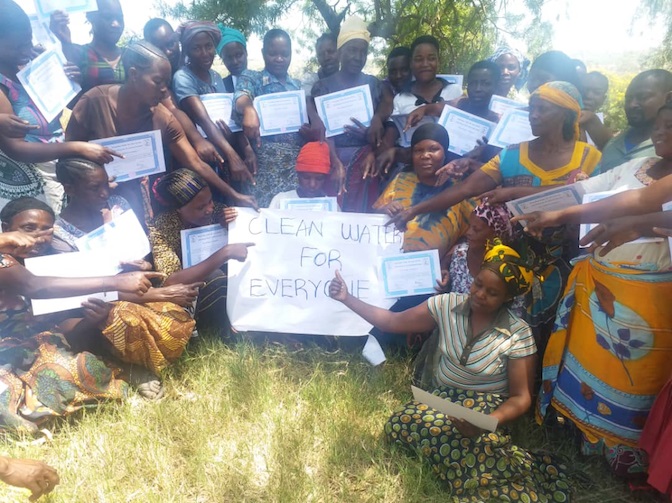 Friendly Water for the World Women with sign Clean Water for Everyone 1