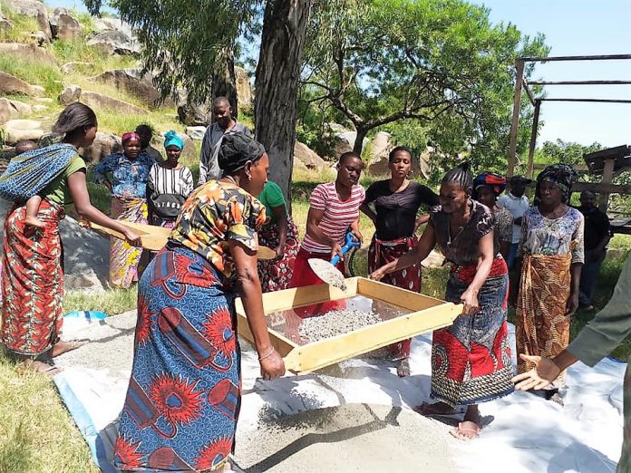 Friendly Water for the World women sifting gravel