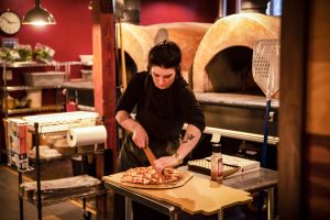 Stone Creek Wood Fired Pizza Employees Slicing Pizza Morgan