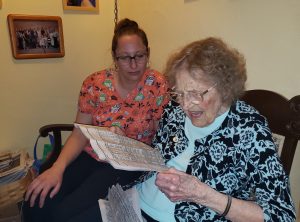 Advanced Health Care Procare Academy Alanna and Lucille with newspaper