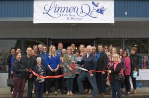 Alongside friends new and old, Linnea Grantham cuts the ribbon to officially open her new store.