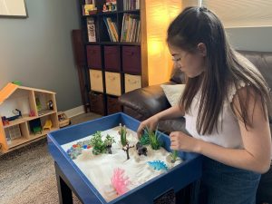 Olympia Therapy Teen using Sandtray Play Therapy to process stress