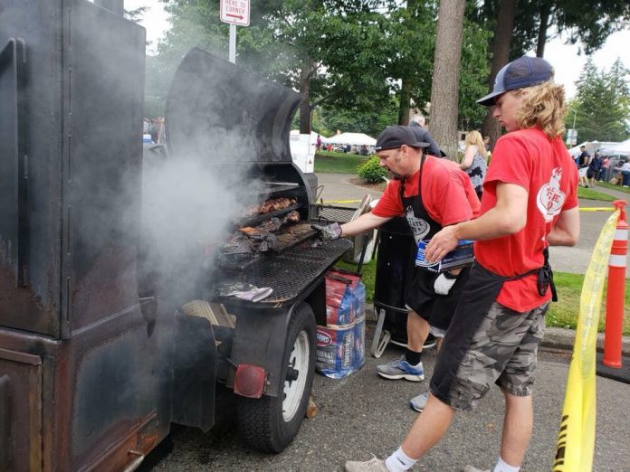 South Sound BBQ Festival workers preparing BBQ on grill at BBQ Festival