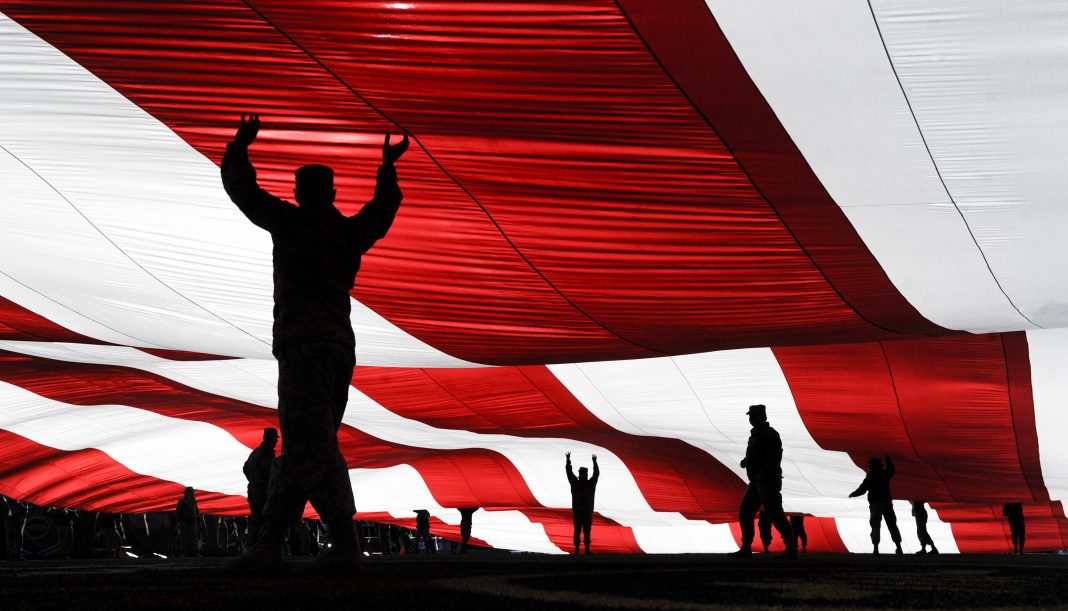 Nellis, Creech Airmen raise American Flag during Las Vegas Bowl