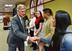 Saint Martin's students shake hands with Dr Heynderickx