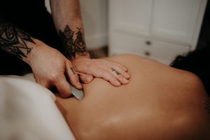 Massage Therapist treating a patient at Ballaura Wellness in Olympia