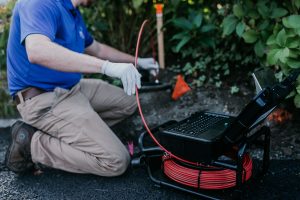 Home inspector using a sewer scope