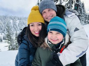 The Smith Family hugging outside in the snow