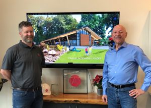 Associate Director of Thomas Architecture Studios Tom Reiger (left) and Chairman Ron Thomas (right) stand in front of the new design presentation of the Brewery Park Visitor Center