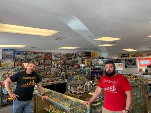 Bryan and Jeff Turner, owners of The Brickhouse LEGO store in Olympia, standing inside their story by a table of LEGO