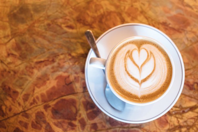 Dancing-Goats-Coffee-Olympia-Washington Latte in a white cup on a brown counter