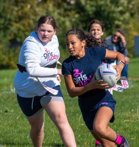 two young girls playing rugby in Thurston County