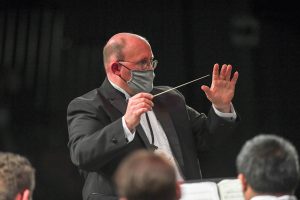 Man conducting a band at River Ridge High School