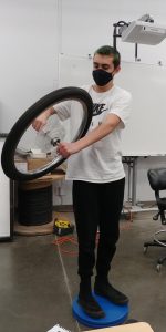 A student holding a bicycle wheel in Power-Up! programs at North Thurston schools