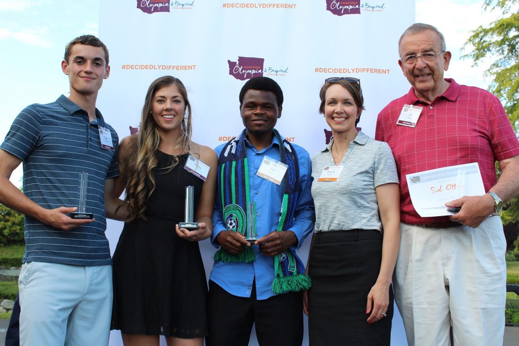 Five people standing with awards at the Experience Olympia & Beyond Sports Awards