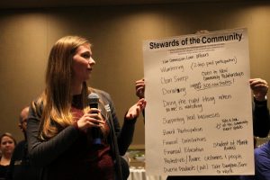 teacher with a big presentation-sized paper pad speaking to class at OlyFed's Bankwork$