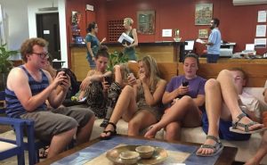 group of teens hanging out on a couch