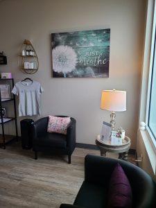 Rejuvenate IV Hydration & Wellness Center  waiting room with leather chairs and a lamp