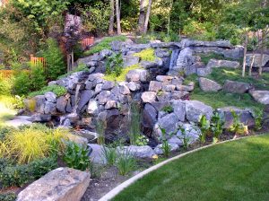 rock water feature in a garden that SCJ Alliance planned