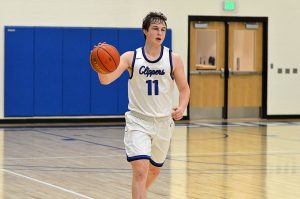 Community College Basketball player Ethan Dillon  dribbling down court