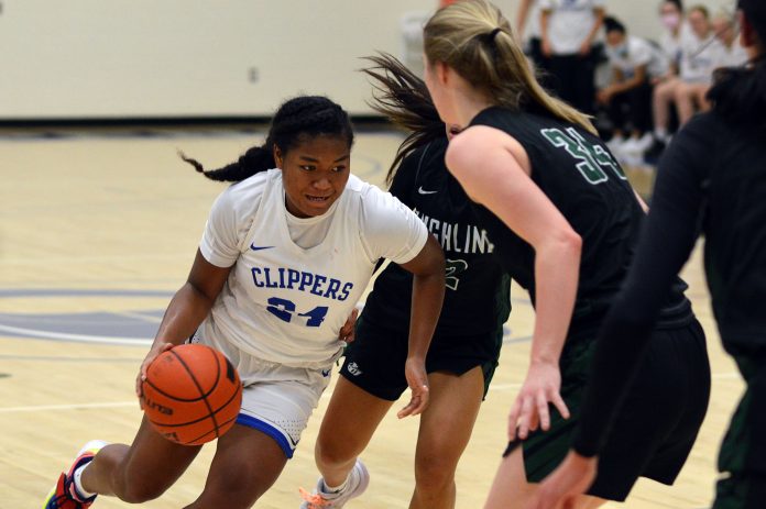 SPSCC women's basketball player dribbling down the court