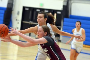 SPSCC women's basketball player blocking an opponent on the court