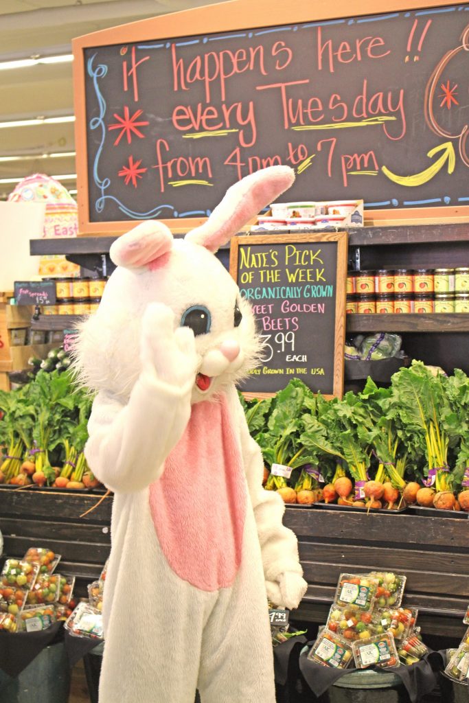 Person dressed as Easter Bunny inside produce department of Thriftway