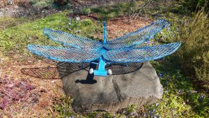 metal dragonfly sculpture on rock in Olympia