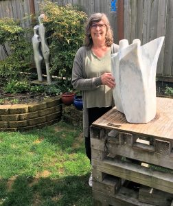 LeeAnn Perry stands by her sculpture called Connections made from marble from Danby, Vermont. 