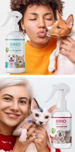 two women, one holding a dog and one holding a hairless cat, next to Briotech cleaning bottles