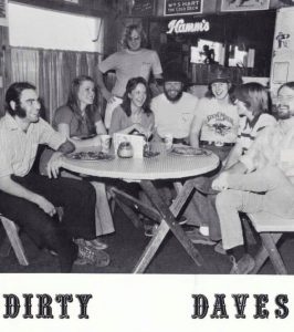 black and white photo of Dave Wilon and at a table with friends