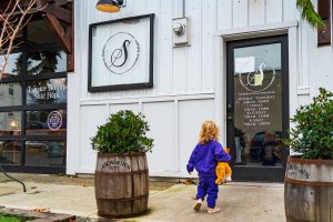 a small child heading towards the door at the Shiplap Shop & Coffeehouse
