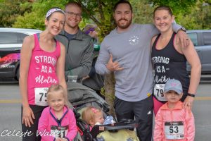 a family of seven with racing numbers from the Family Support Center