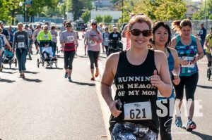 people running in the street at the Family Support Center's Mother's Day 5k