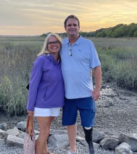 Becky Carver and husband Ron of PrimeLending stand in some rocks and grass