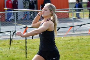 Rainier High School senior Isabella Holmes holding the javelin