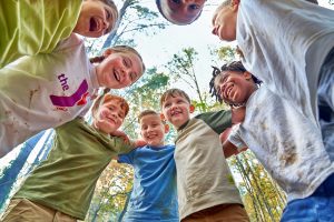 group of smiling young kids in a huddle