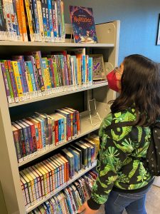 Youth browsing books at Hawks Prairie Timberland Regional Library