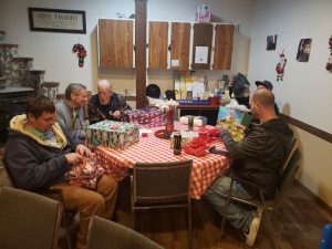 group of people at a table at Truly Motivated Transitional Living