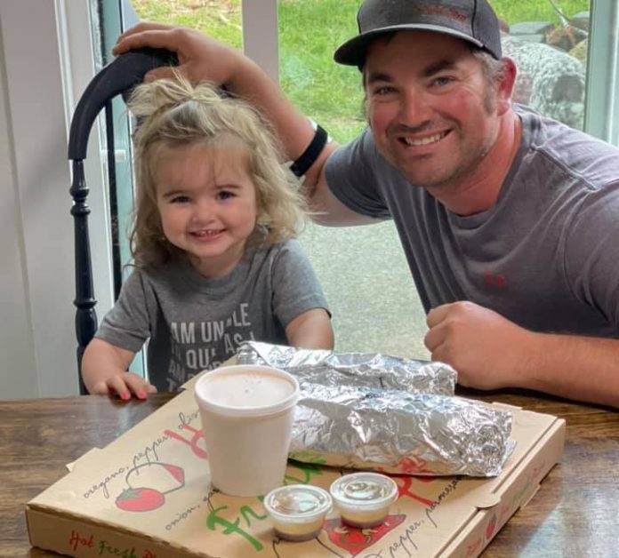 Kevin and daughter, Olivia siting at kitchen table with Dirty Dave's Pizza delivery for All Kids Win