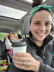 Woman holding coffee cup from South Bay Coffee for All Kids Win Fundraiser