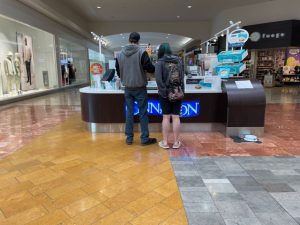 people standing at the Cinnabon counter at Capital Mall