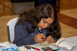 Child at a craft table at Capital Mall