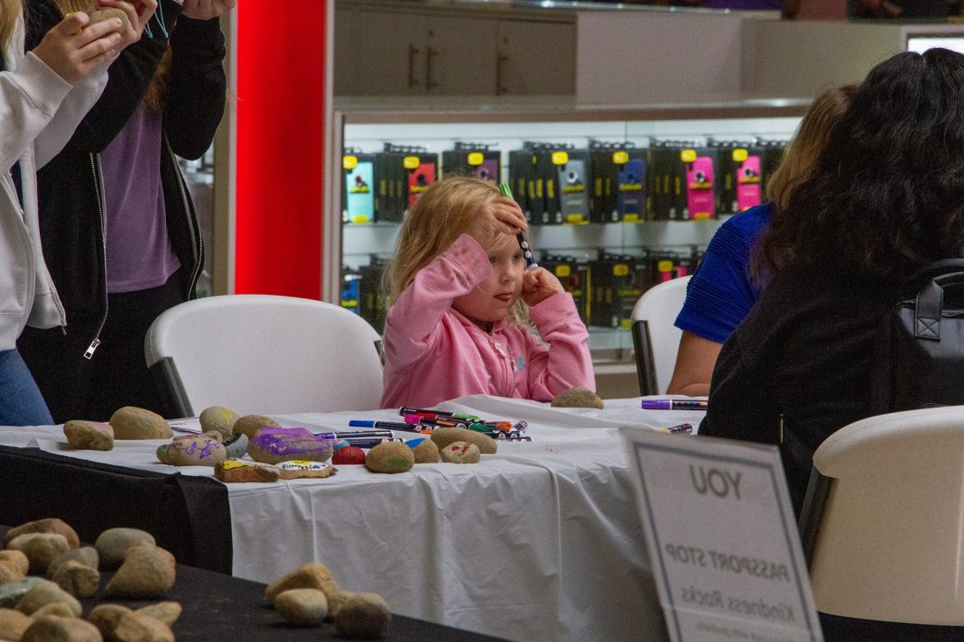 Child at a craft table at Capital Mall