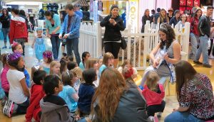 group of kids sitting and listening to a speaker at the Capital Mall