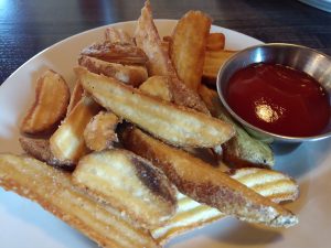 Iron Rabbit wedge fries with ketchup on a plate