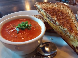 Iron Rabbit's tomato basil soup and grilled cheese on a plate
