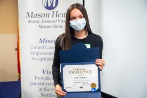 Carly VanAagten holding Mason Health scholarship