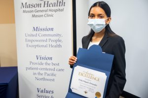 Eryka Delgado-Hernandez holding Mason Health Scholarship